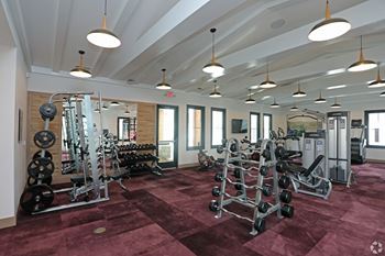 A gym with a variety of equipment including weights and weight machines.at 198 Milltown Apartments, Burlington North Carolina  